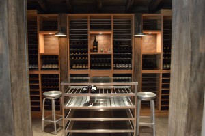 Elegant Wine Racks and a Brushed-Stainless Steel Wine Table Designed for a Modern Custom Wine Cellar