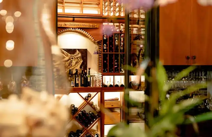 Traditional Wine Cellar Design with wooden wine racks and X-bins and wine table top.