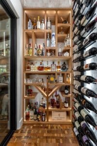 Modern wine room floor to ceiling custom wood wine rack dedicated for tequila bottles