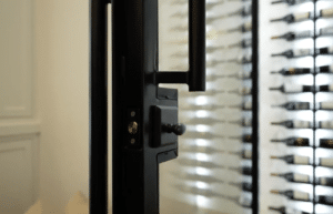 Modern wine closet under the stairs with metal door handle
