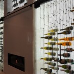 Wine bottles look like they're floating in mid-air when suspended by the cable wine racking system.