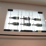 This small wine closet sits close to the ceiling, and is accessible via the rolling ladder.