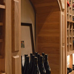 Upon entering this wine cellar, you'll see this wooden arch on the right. It has a relatively high ceiling height within our wooden wine racks, so the owner could also display his magnum bottles, champagne bottles, gins, burgundy, etc.