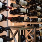 The wine pegs in this glass wine room are manufactured in different finishes. We used chrome since we thought it suit the overall aesthetic better.