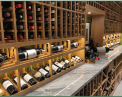 3- A marble countertop adds a luxurious touch to this modern glass wine cellar.