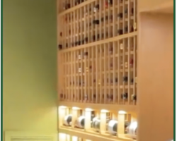 4 - This modern glass wine cellar's water-cooled cooling unit is mounted on the wall and painted the same green color so it doesn't take away attention.